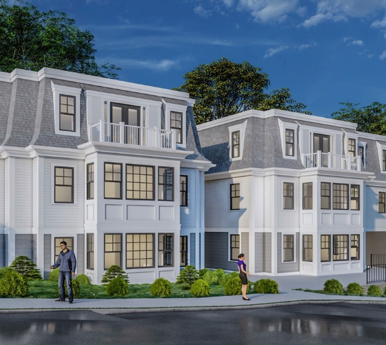 Matching white townhomes with balconies side-by-side