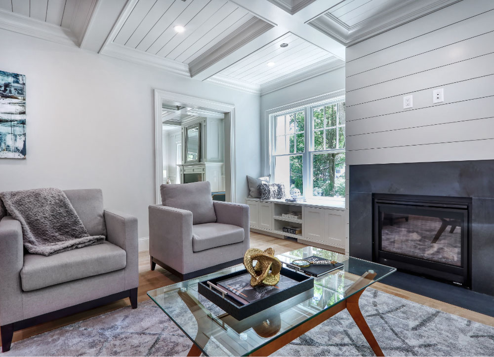 Grey living room with fireplace and bay window seat