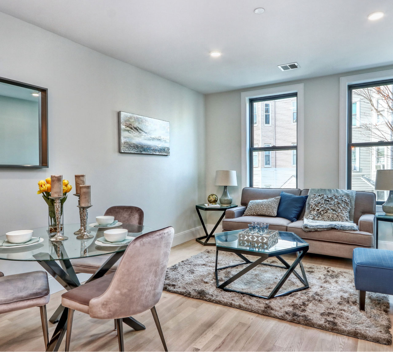 Open concept living and dining areas with grey and blue color scheme