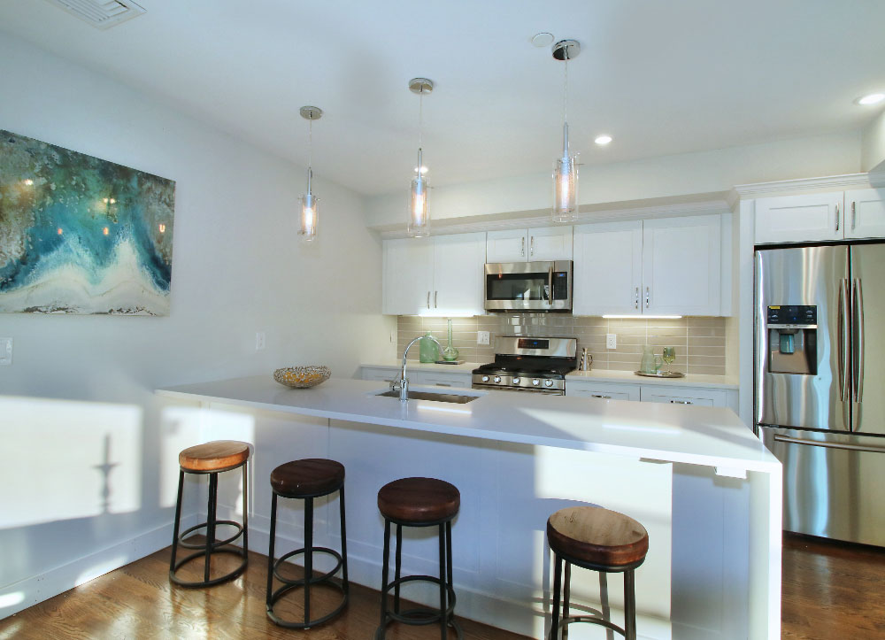 Kitchen with bar seating and stainless steel appliances