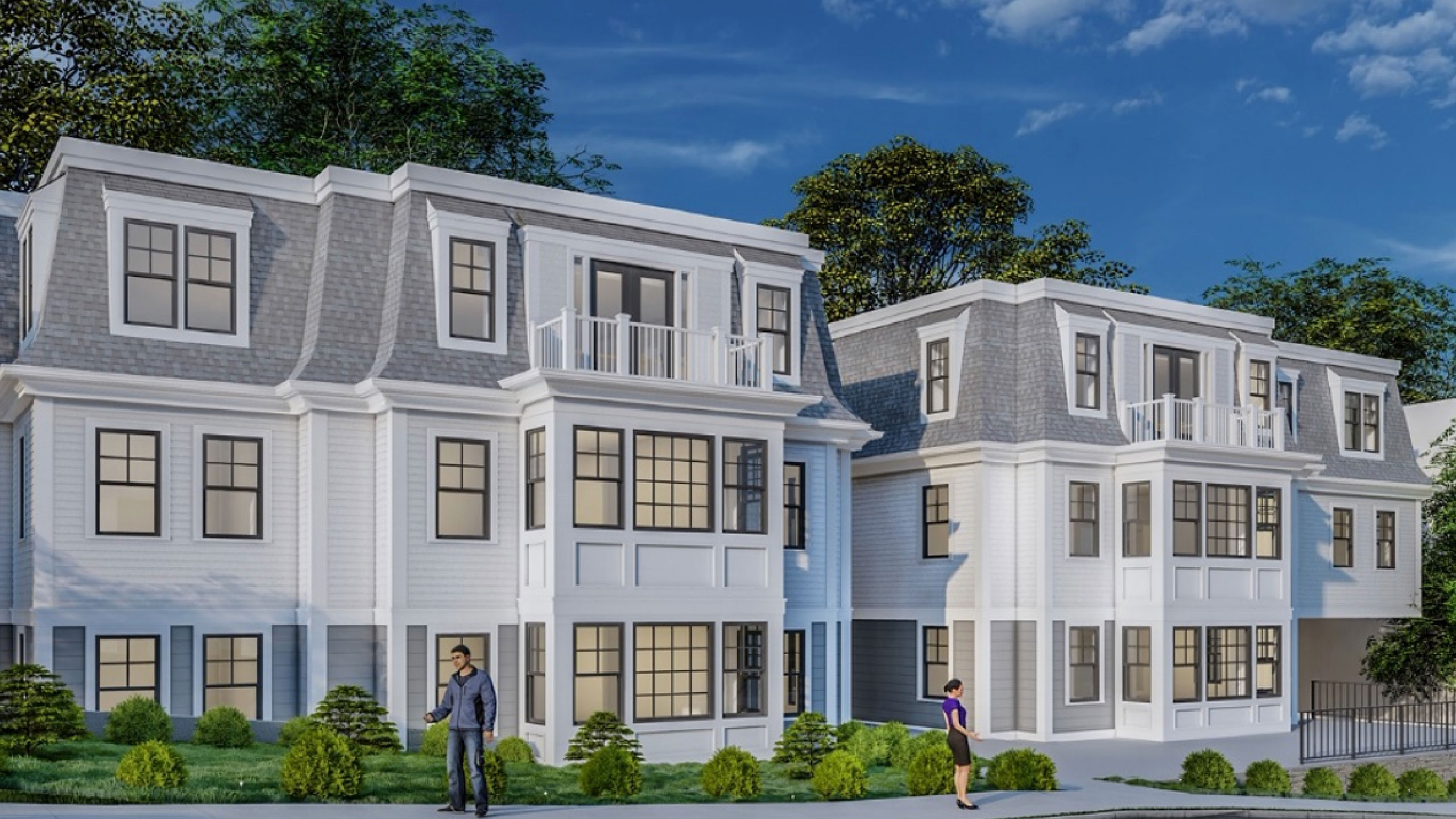Matching white townhomes with balconies side-by-side